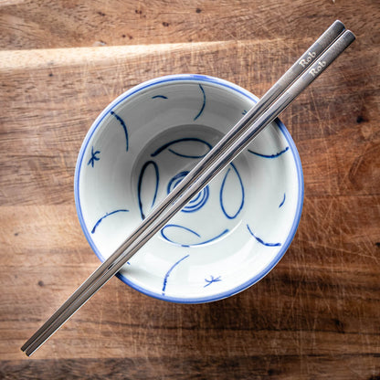 A pair of Chinese-style Metal Coloured Chopsticks - Silver. Each pair is personalised with either a name or a phrase.
