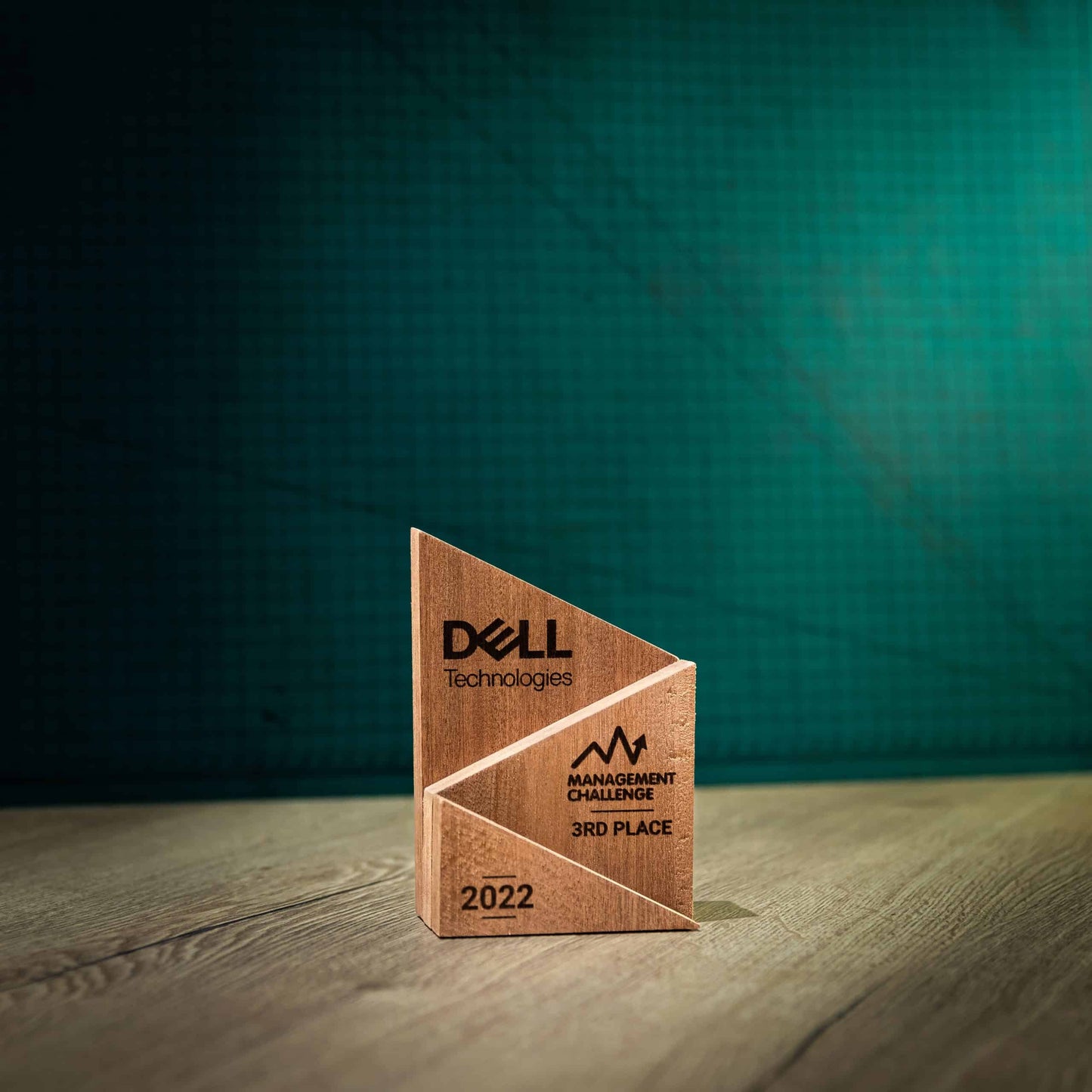 A small laser-engraved, eco-friendly, Peak wooden trophy.