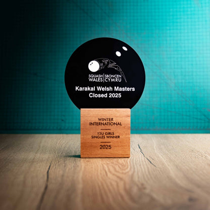 A large Squash trophy with custom text and logos, on an eco-friendly wooden base, with a black Perspex Squash ball mounted on top, featuring fully customisable areas for text and logos.