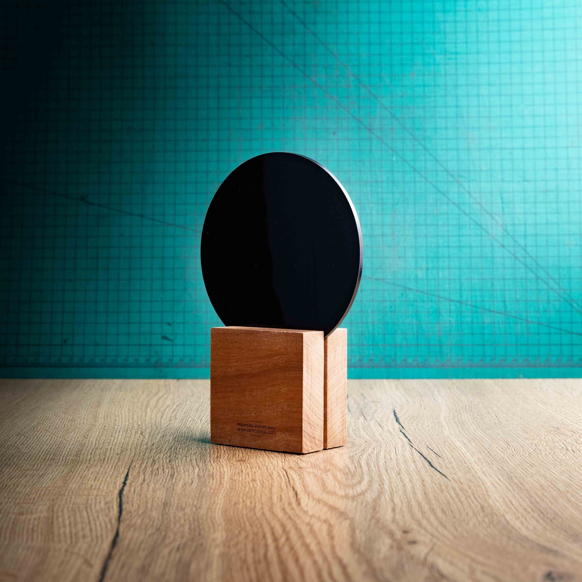 The back of a medium Squash trophy with custom text and logos, on an eco-friendly wooden base, with a black Perspex Squash ball mounted on top, featuring fully customisable areas for text and logos.