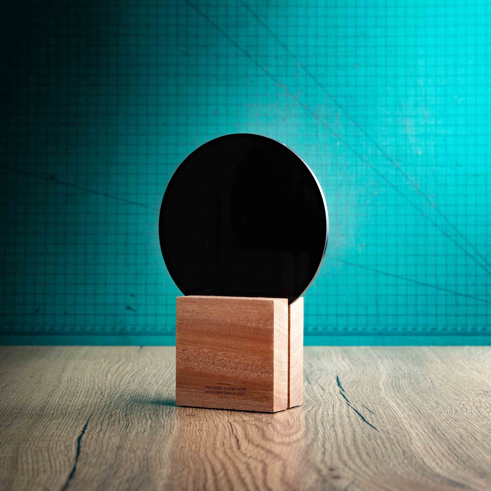 A back view of a medium Tennis trophy with custom text and logos, on an eco-friendly wooden base, with a black Perspex Tennis ball mounted on top, featuring fully customisable areas for text and logos.