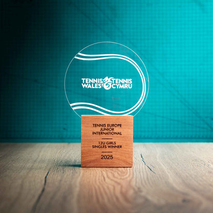 A large Tennis trophy with custom text and logos, on an eco-friendly wooden base, with a clear Perspex Tennis ballmounted on top, featuring fully customisable areas for text and logos.