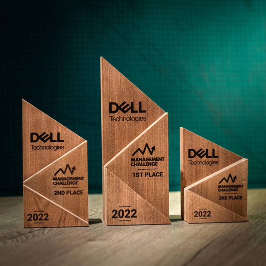 Three laser-engraved, eco-friendly, wooden trophies in a peak design with three staggered wooden blocks, small, medium and large.