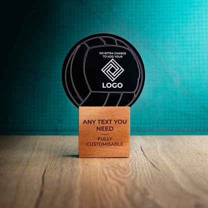 A large Volleyball trophy with custom text and logos, on an eco-friendly wooden base, with a black Perspex Volleyball mounted on top, featuring fully customisable areas for text and logos.