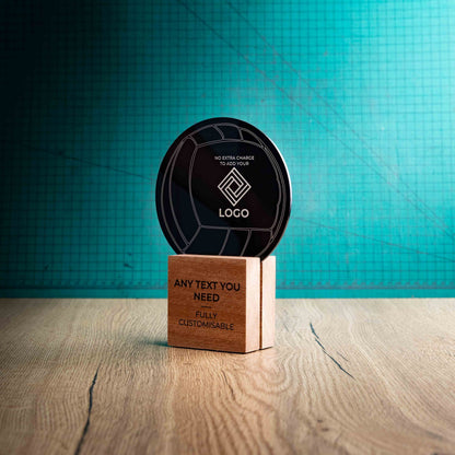 A side view of a medium Volleyball trophy with custom text and logos, on an eco-friendly wooden base, with a black Perspex Volleyball mounted on top, featuring fully customisable areas for text and logos.
