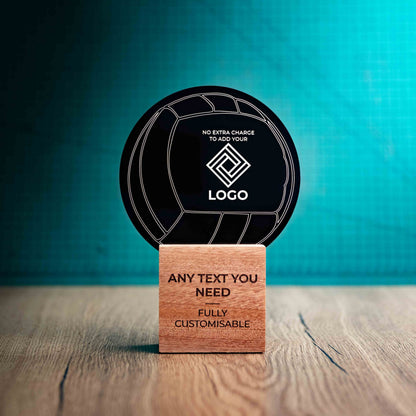 A medium Valleyball trophy with custom text and logos, on an eco-friendly wooden base, with a black Perspex Volleyball mounted on top, featuring fully customisable areas for text and logos.