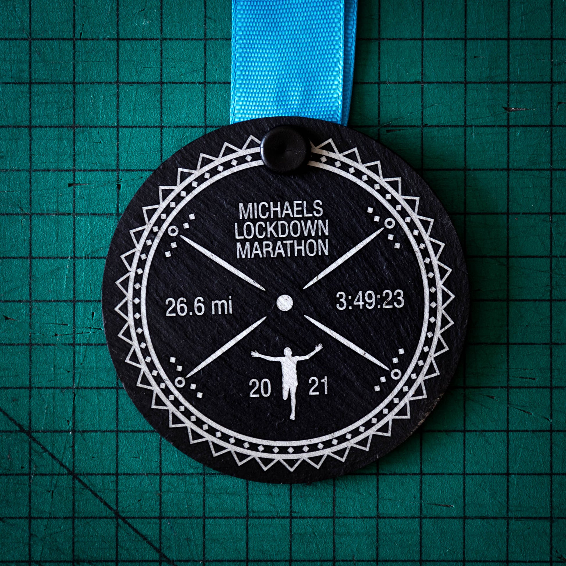 A personalised laser engraved Welsh slate sports medal