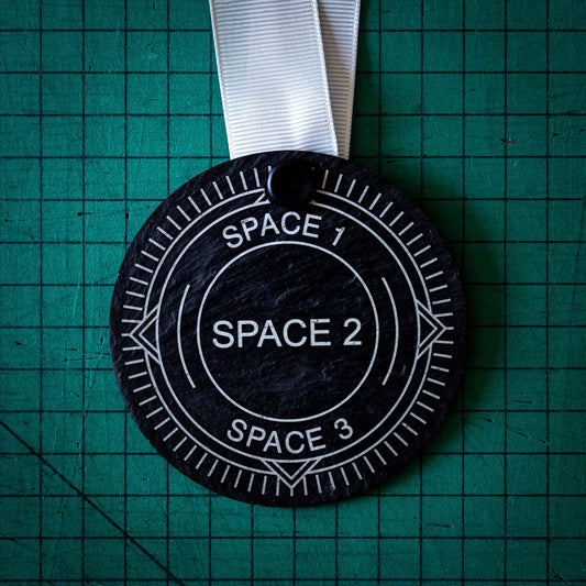 A personalised laser engraved Welsh slate sports medal