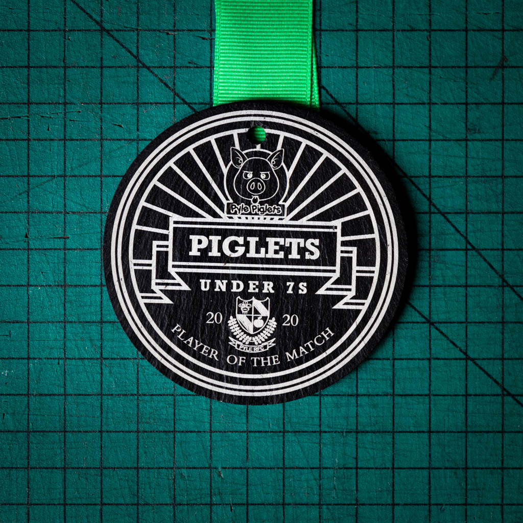 A personalised laser engraved Welsh slate running medal
