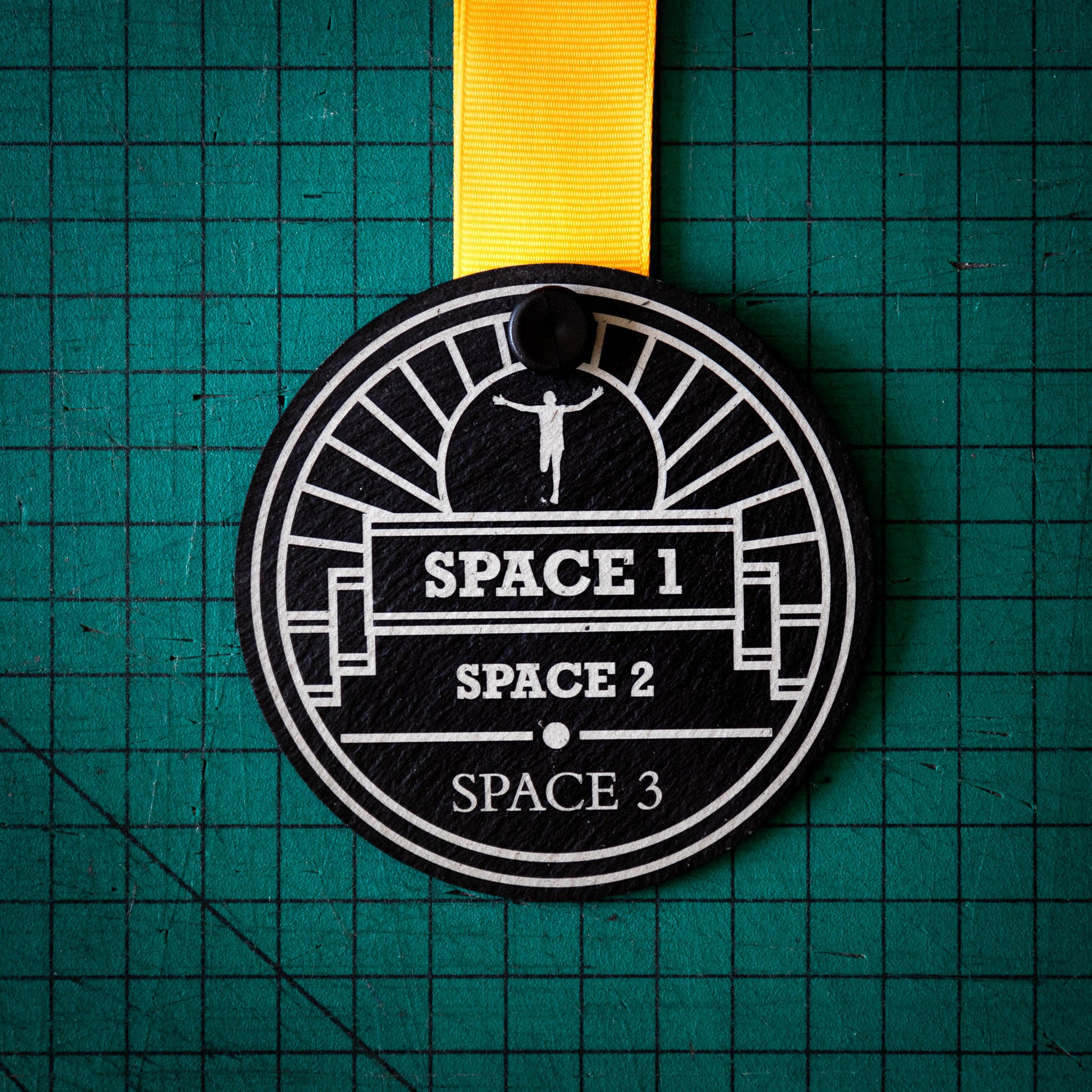 A personalised laser engraved Welsh slate sports medal