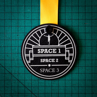 A personalised laser engraved Welsh slate sports medal