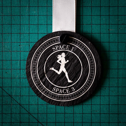 A personalised laser engraved Welsh slate sports medal