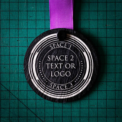 A personalised laser engraved Welsh slate sports medal