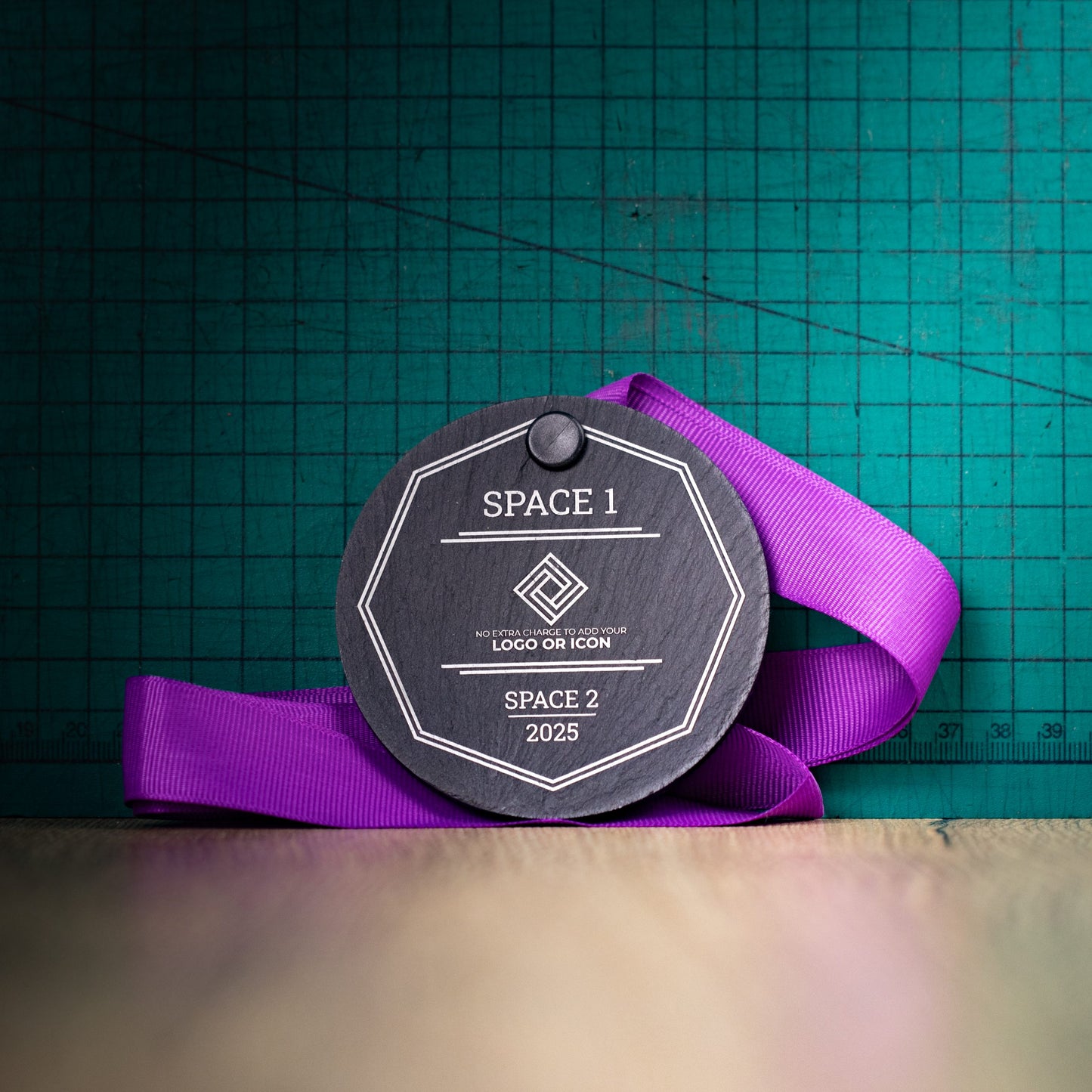 A personalised laser engraved Welsh slate sports medal