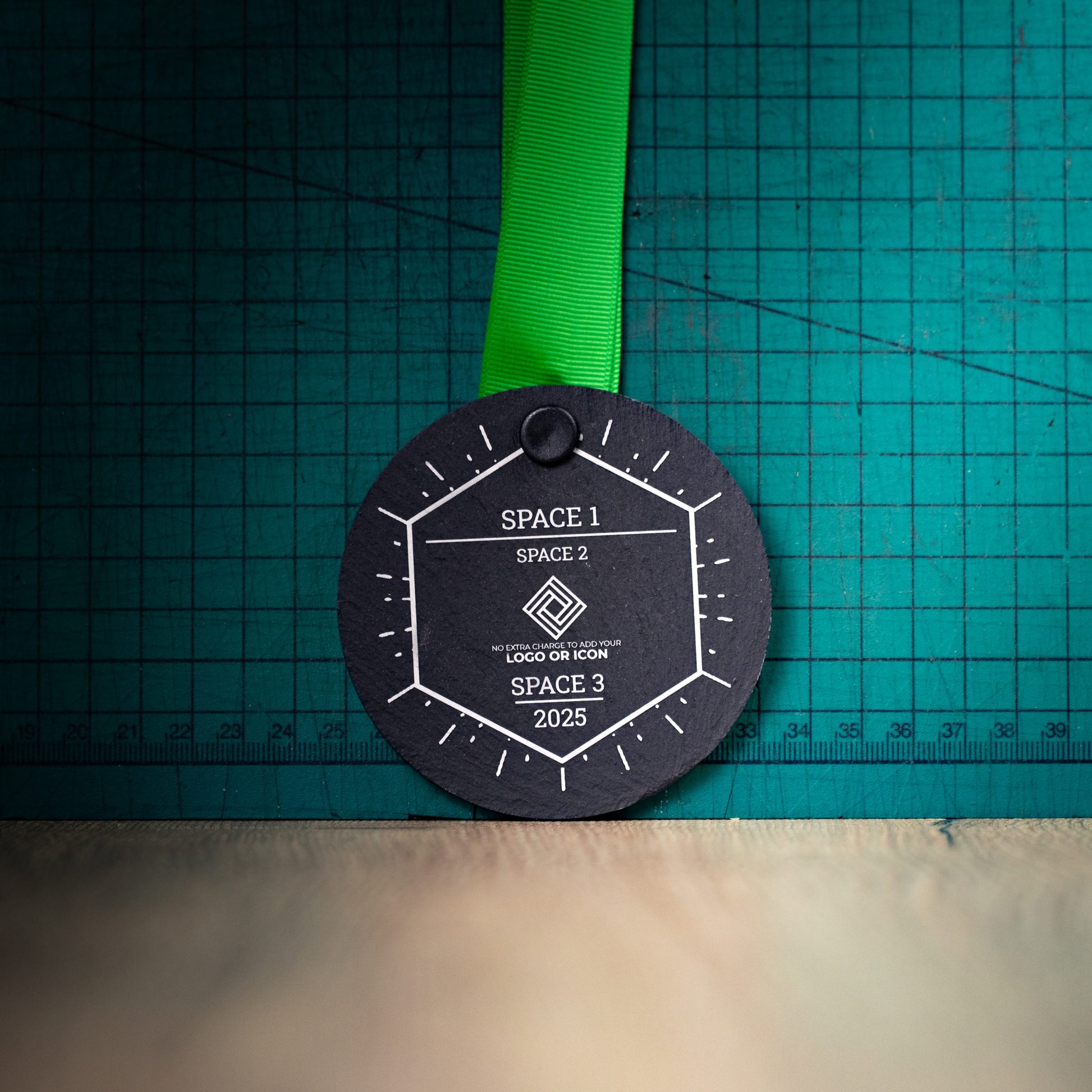 A personalised laser engraved Welsh slate sports medal