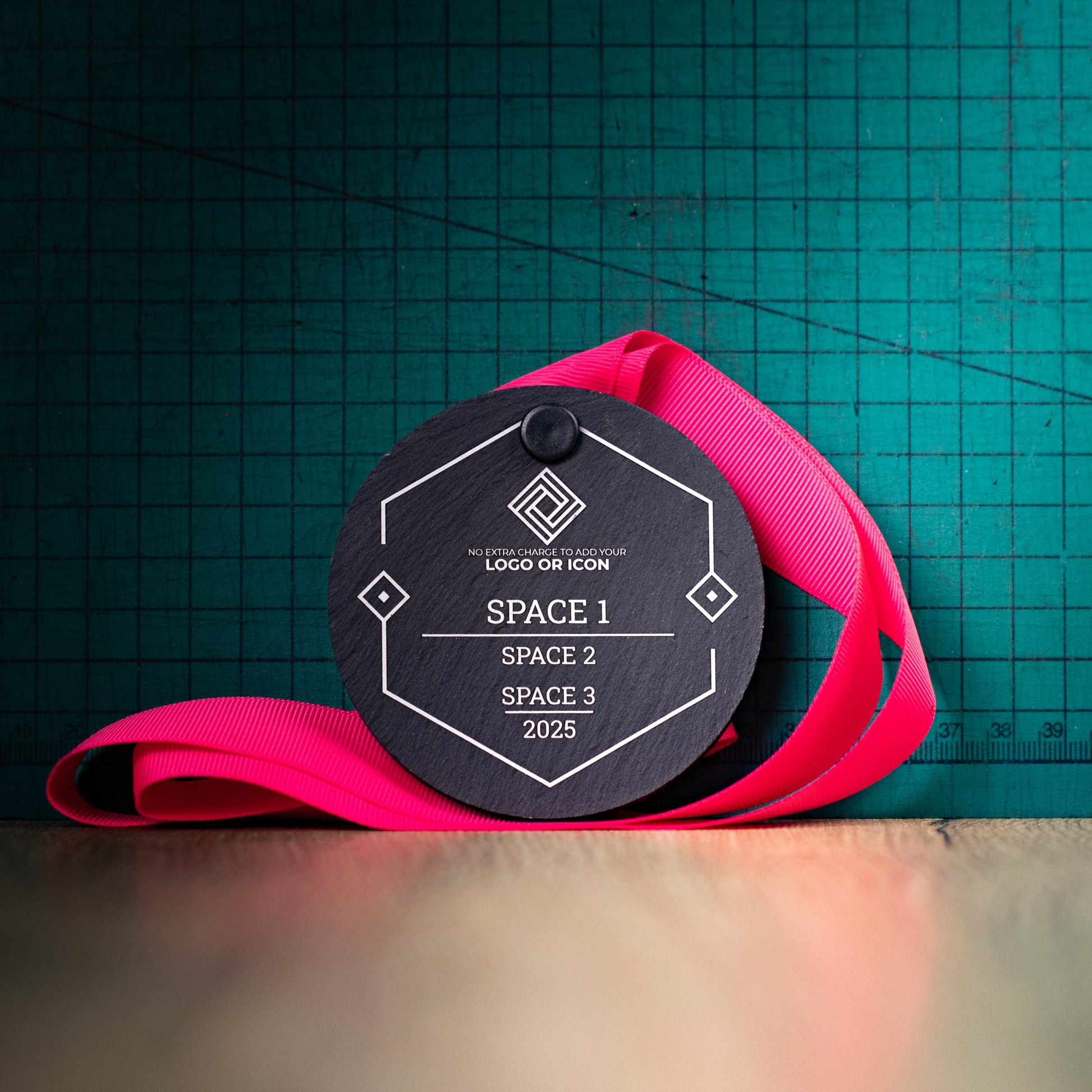 A personalised laser engraved Welsh slate sports medal