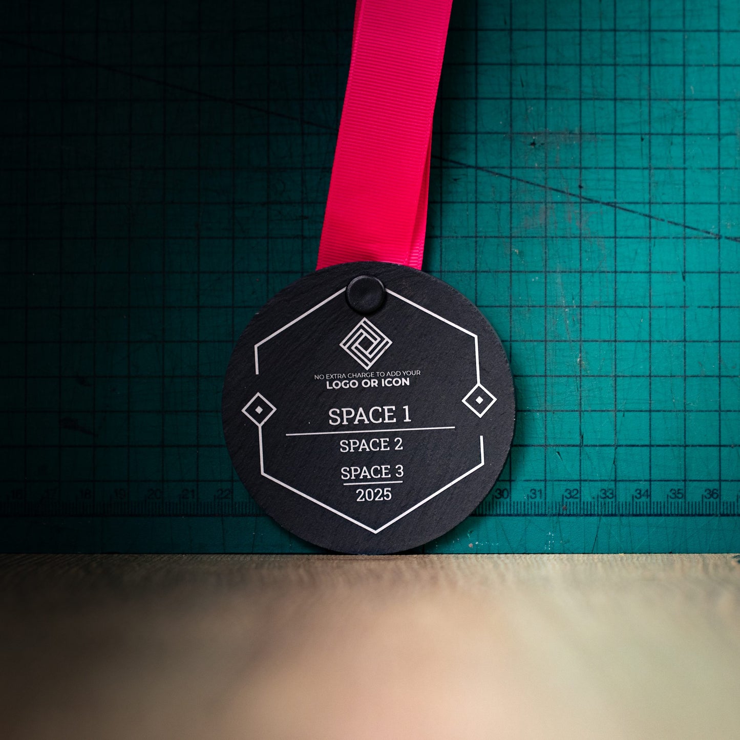 A personalised laser engraved Welsh slate sports medal