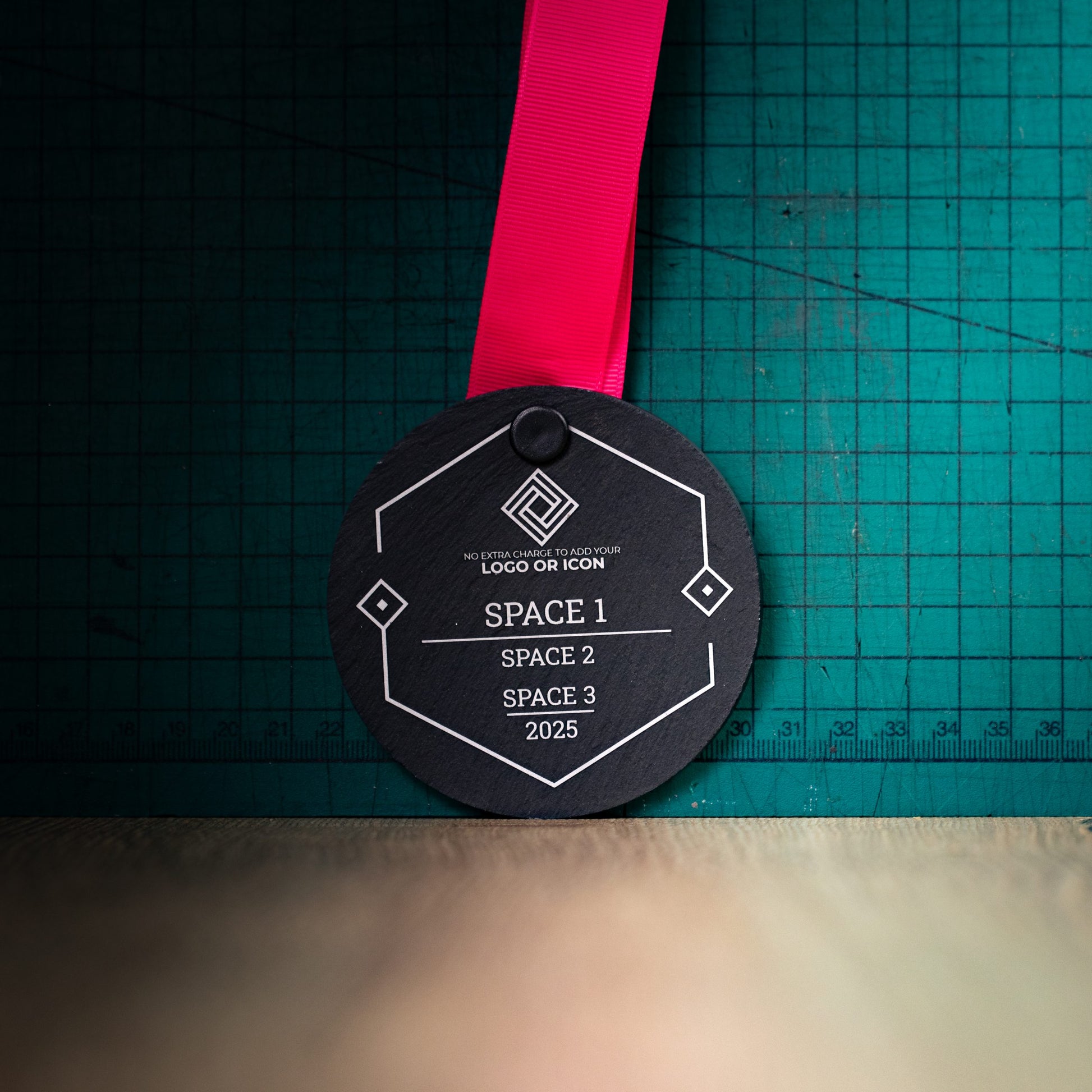 A personalised laser engraved Welsh slate sports medal
