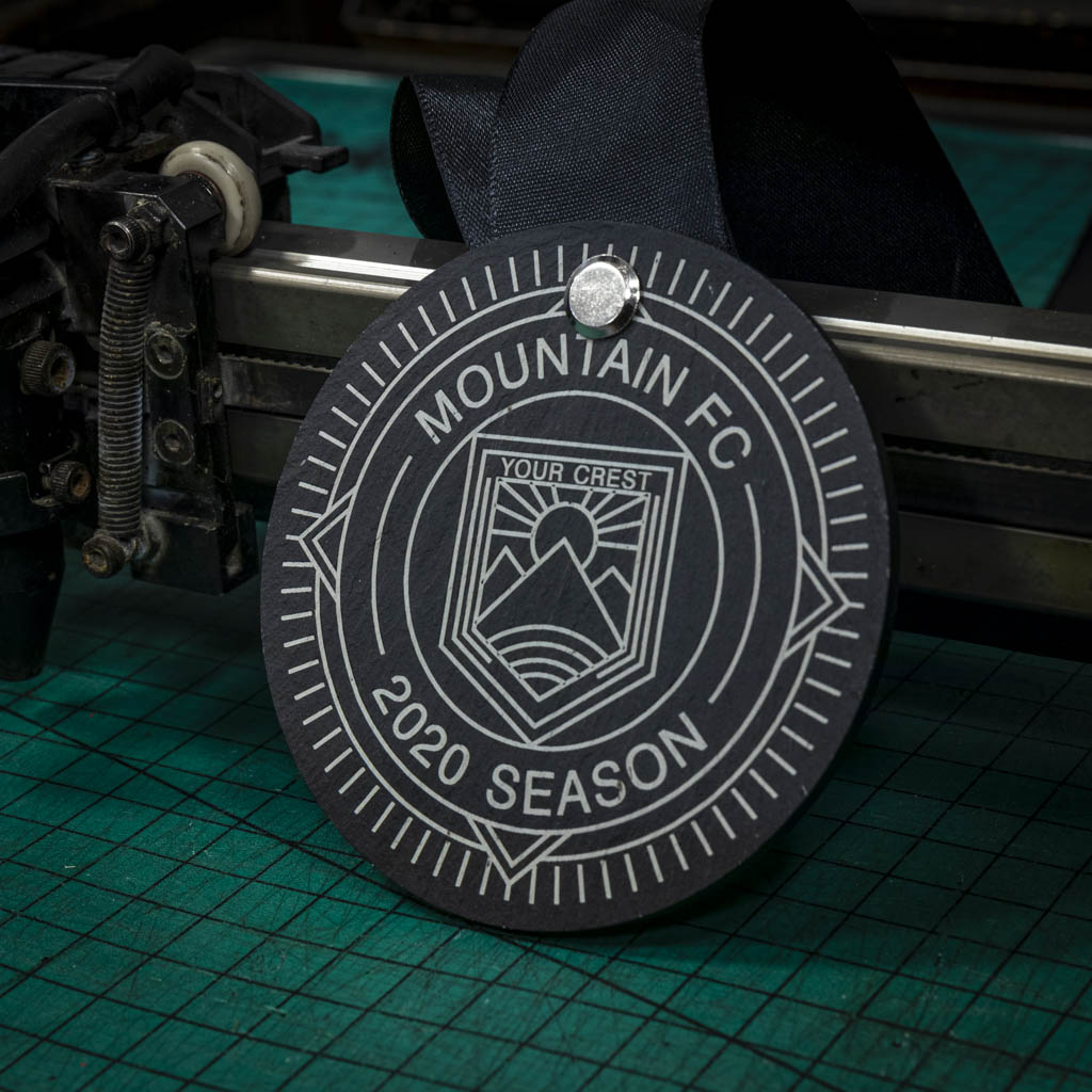 A personalised laser engraved Welsh slate running medal