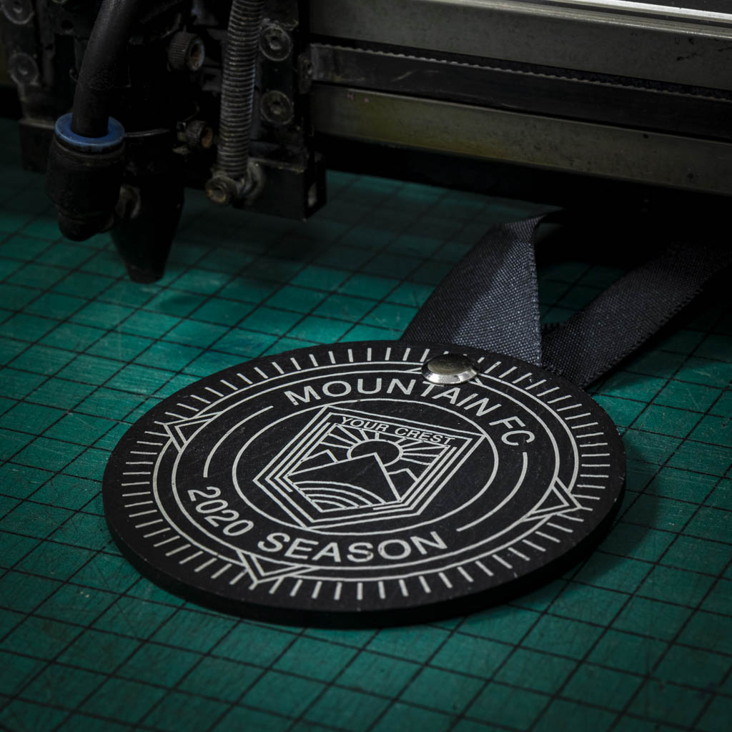 A personalised laser engraved Welsh slate running medal