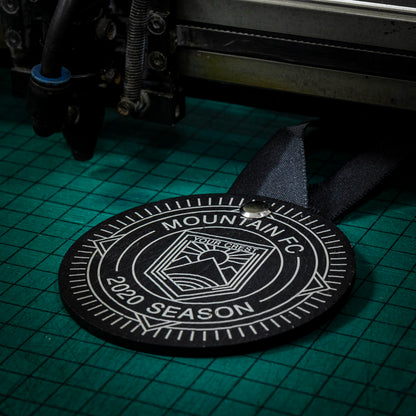 A personalised laser engraved Welsh slate running medal