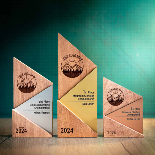 The Metallic Peak Trophy range, eco-friendly personalised wooden trophies. Triangular-shaped wooden trophies laser engraved with a logo and trophy personalisation. The front of the metallic trophies has gold, silver or bronze acrylic fronts.