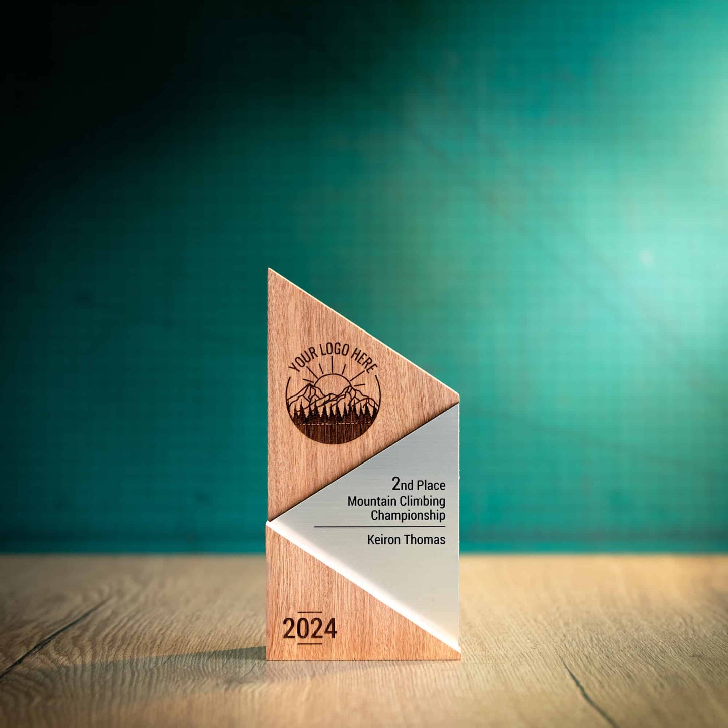 A Medium Metallic Peak Trophy, an eco-friendly personalised wooden trophy. A Triangular wooden trophy laser-engraved with a logo and trophy personalisation. The front of the metallic trophies has gold, silver or bronze acrylic fronts.