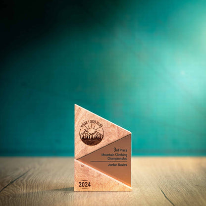 A Small Metallic Peak Trophy, an eco-friendly personalised wooden trophy. A Triangular wooden trophy laser-engraved with a logo and trophy personalisation. The front of the metallic trophies has gold, silver or bronze acrylic fronts.