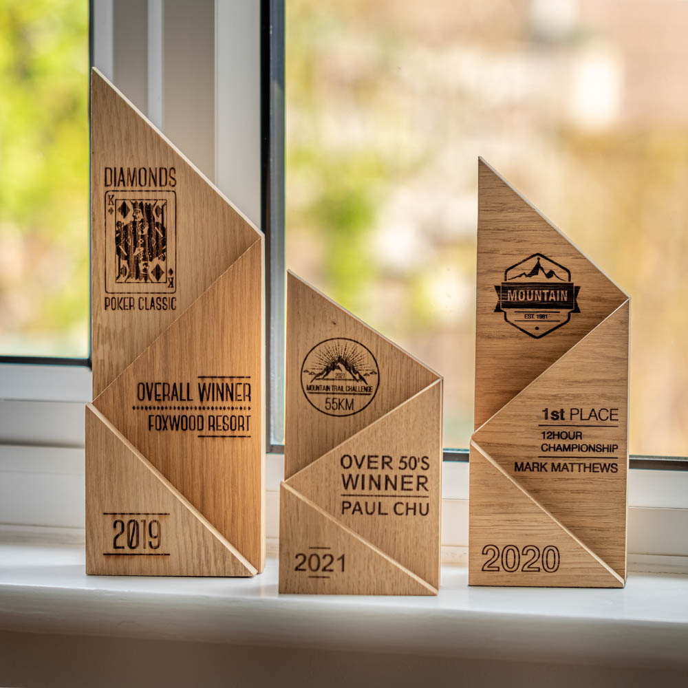 A small, medium and large laser engraved, eco-friendly, wooden trophy