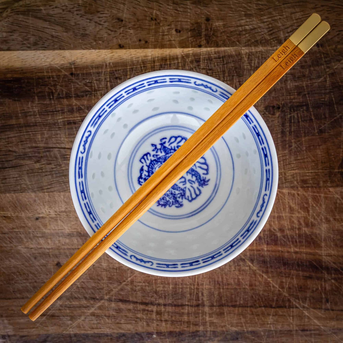A pair of personalised Metallic Ended Light Wooden Chopsticks laser engraved with a name of your choice