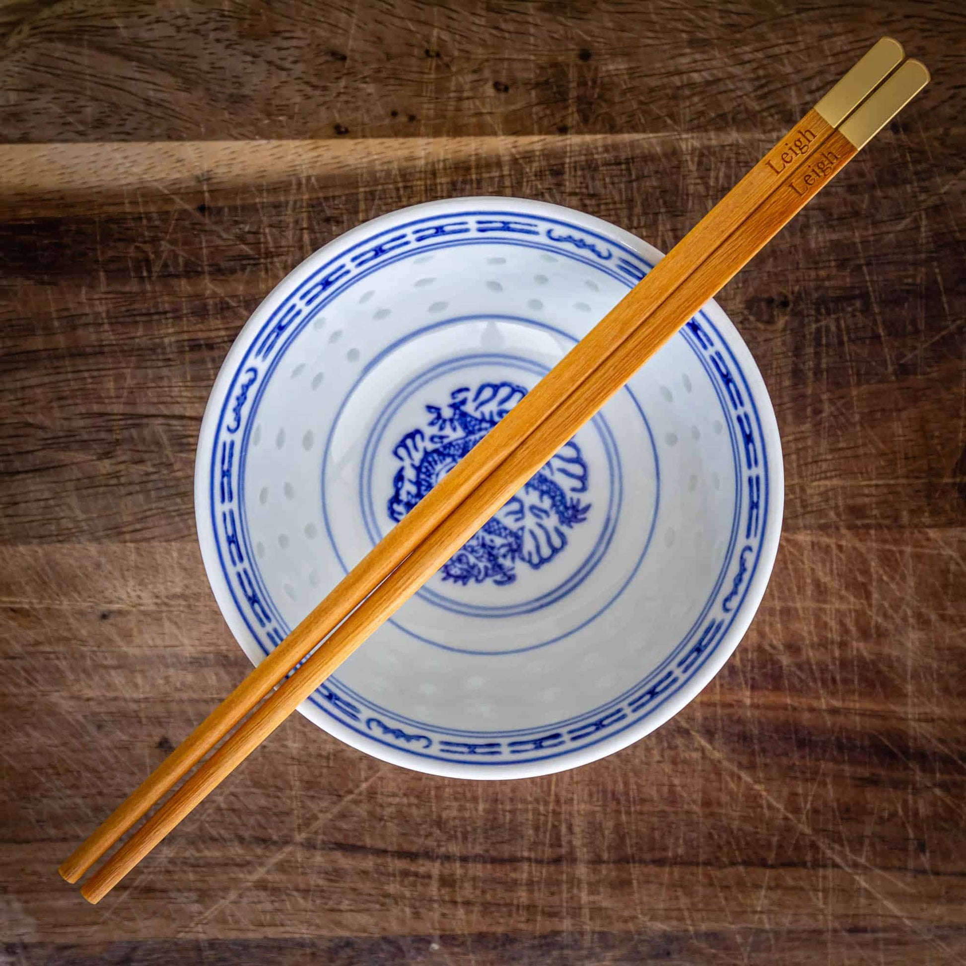 A pair of personalised Metallic Ended Light Wooden Chopsticks laser engraved with a name of your choice