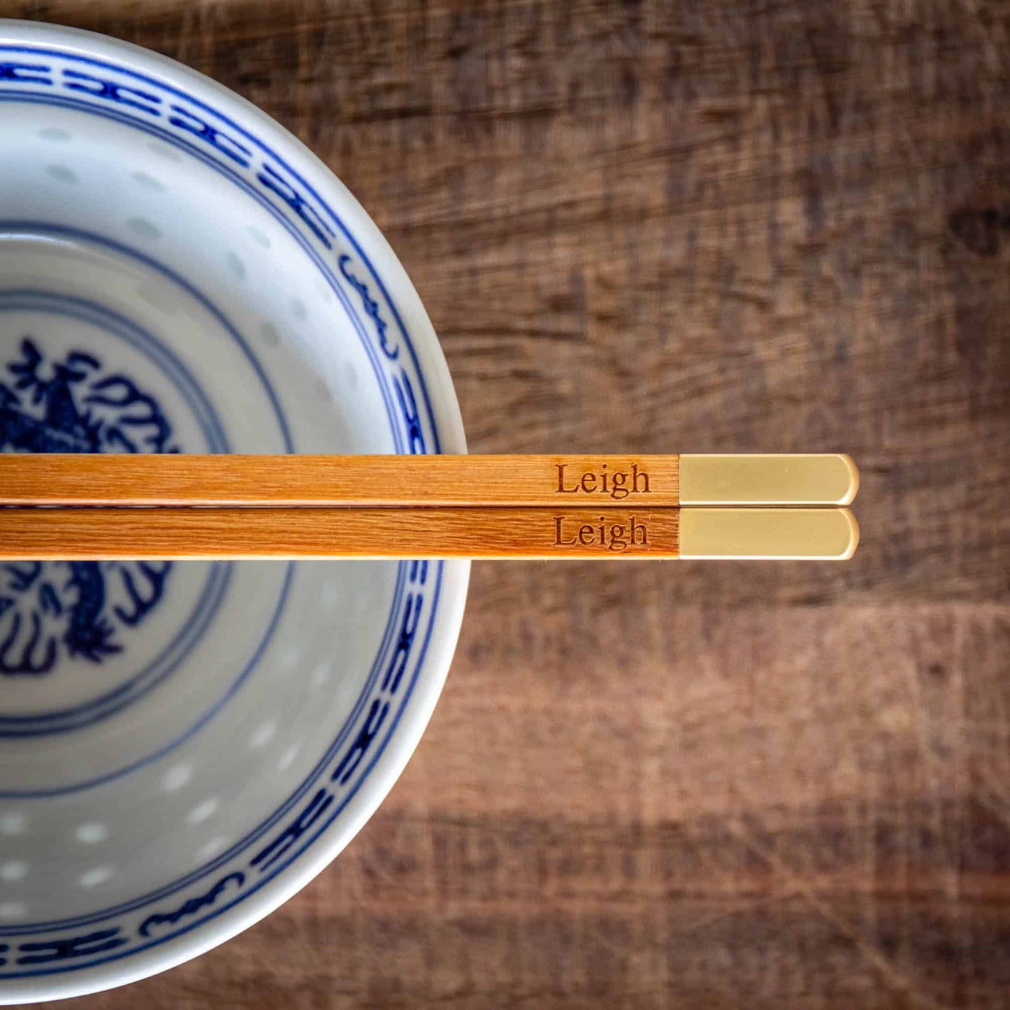 A pair of personalised Metallic Ended Light Wooden Chopsticks laser engraved with a name of your choice