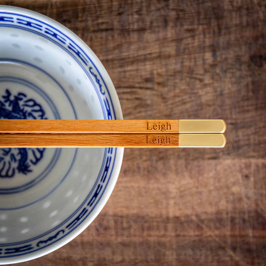 A pair of personalised Metallic Ended Light Wooden Chopsticks laser engraved with a name of your choice